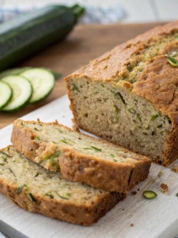 A slice of gluten free zucchini bread with butter