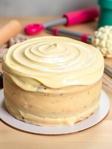 gluten-free vanilla cake, its buttercream frosting gleaming.